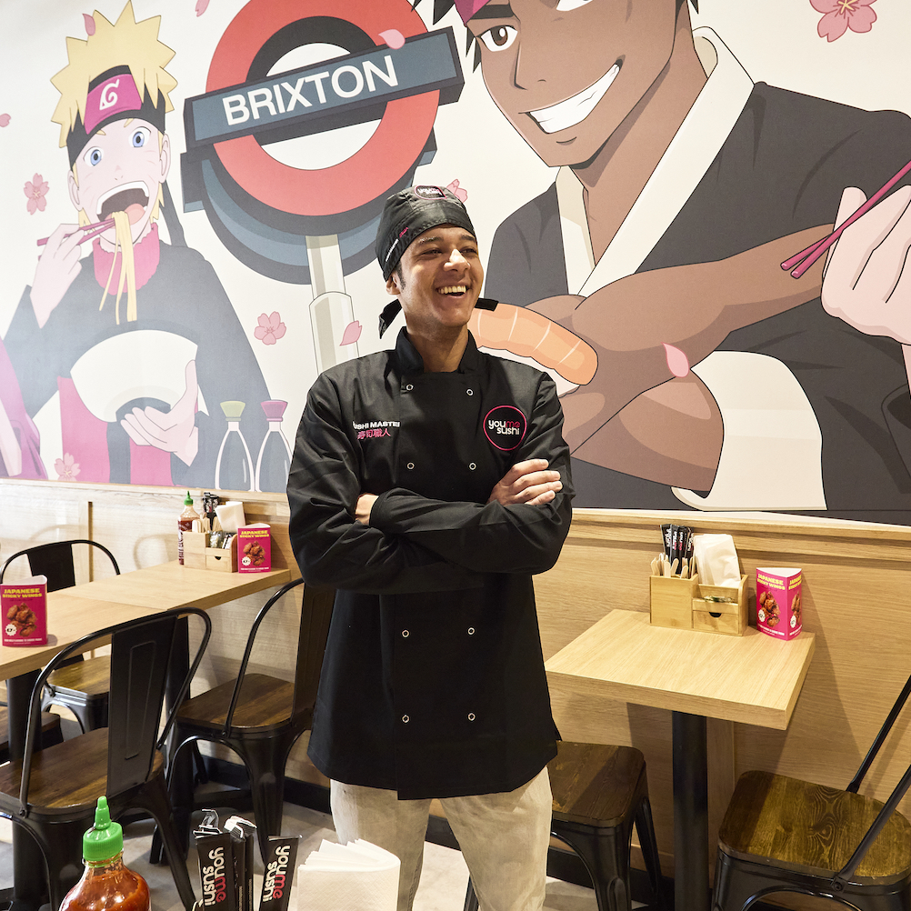 Sushi chef laughing while in a YouMeSushi restaurant