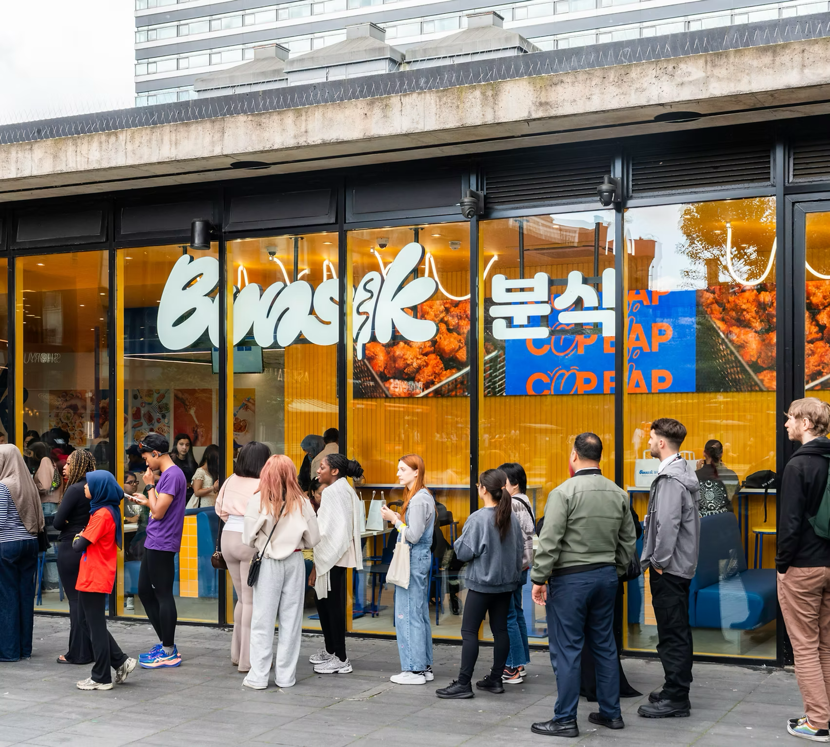 A queue of customers outside a Bunsik restaurant
