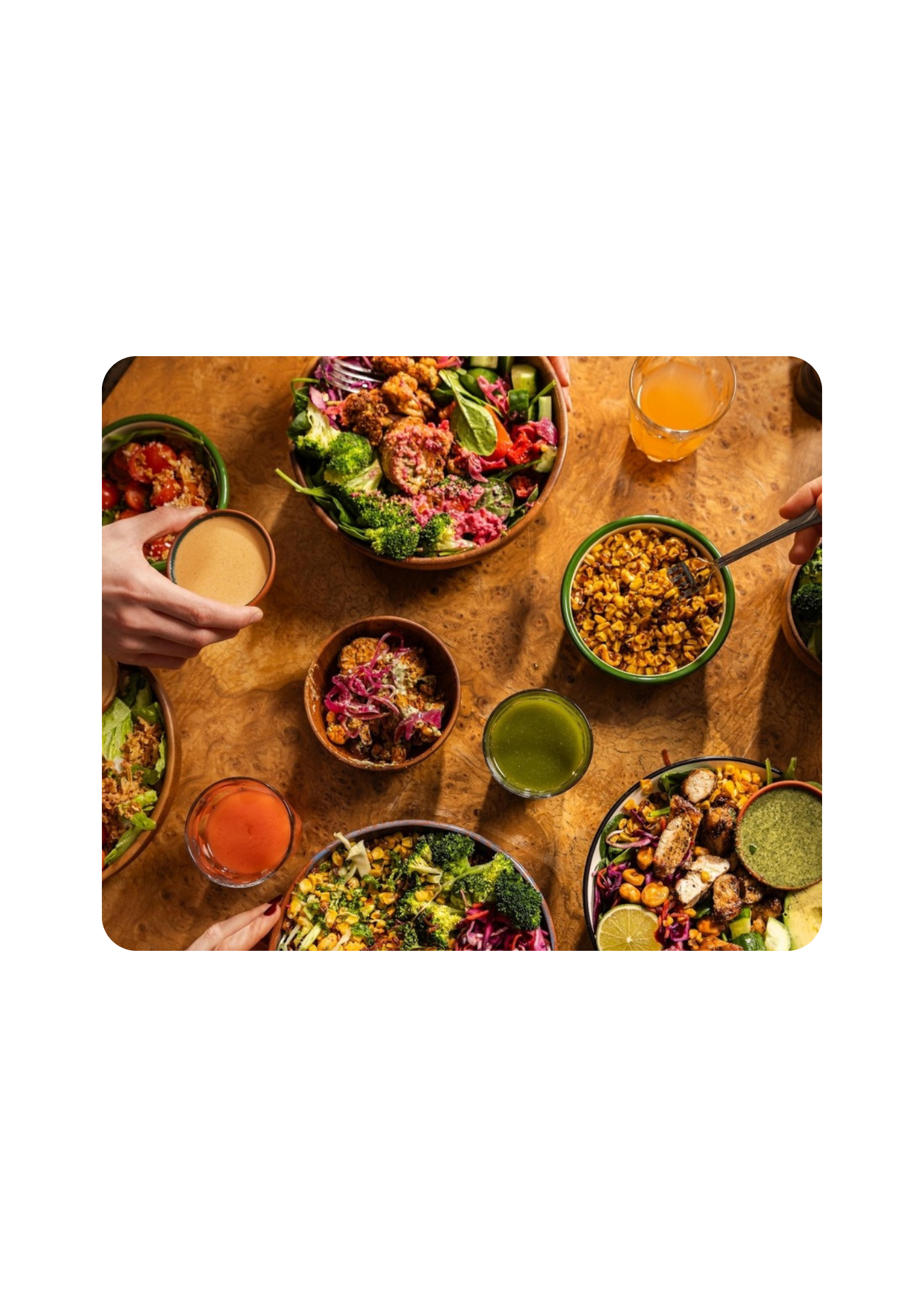 People sharing salad over a table